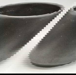 LAVERNE CALIF USA CERAMICS Black Cylinder Planter: LAVERNE CALIF USA CERAMICS Black Cylinder Planter / Vase. Underside signed LAVERNE CALIF USA CERAMICS C6, other verbiage illegible. Thick walled. Measures approx. 5.5H x 7.W in. Pitting, losses to fin
