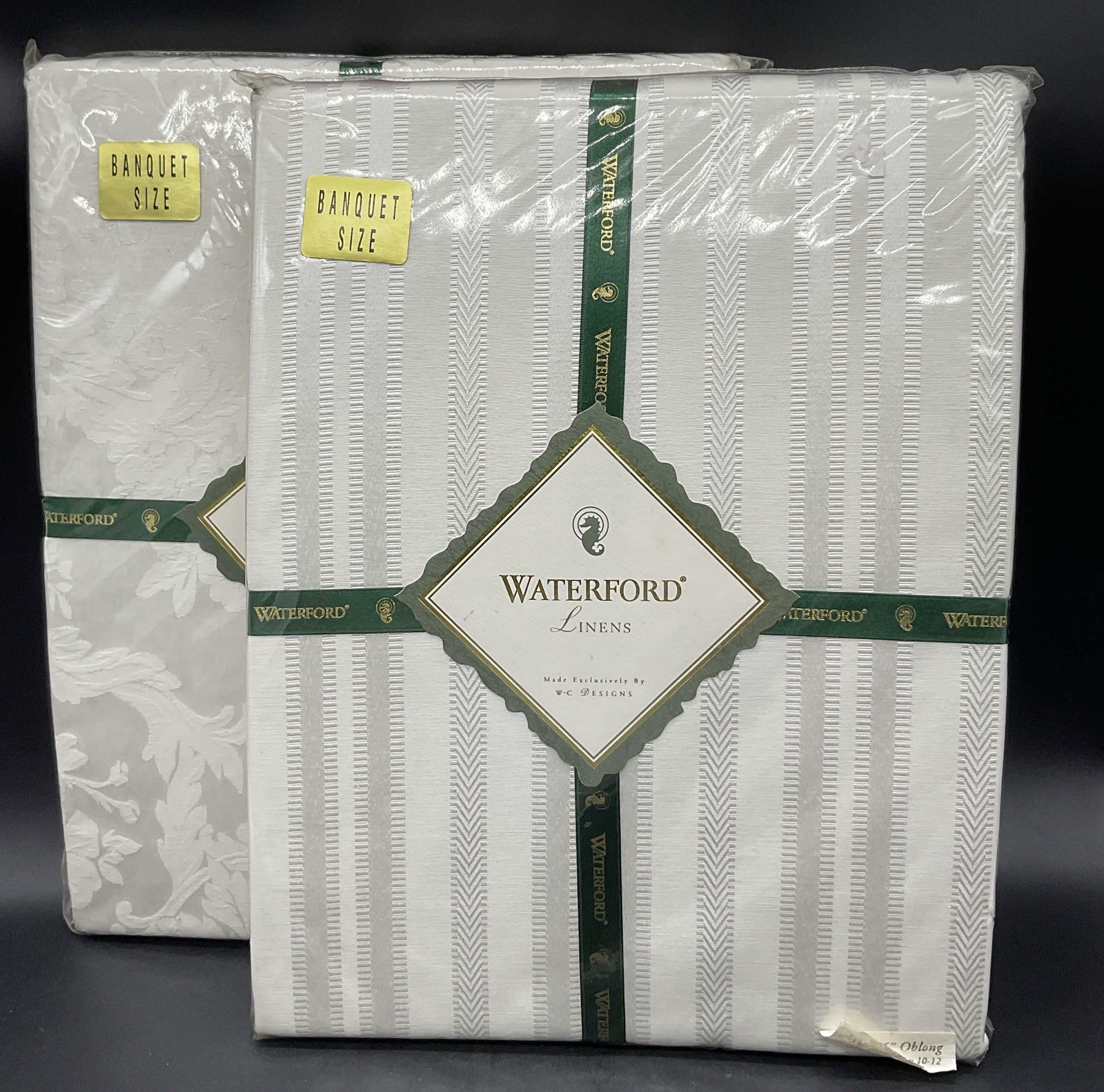 Lot 2 NIP WATERFORD LINENS Banquet Sz Tablecloths: Lot 2 NEW IN PACKAGE WATERFORD LINENS Banquet Size Tablecloths. One has sticker that reads 68 in by 126 in, oblong. Includes Barons Court and Barons Stripe. Pieces are vintage from 1995 and 1997. Cont