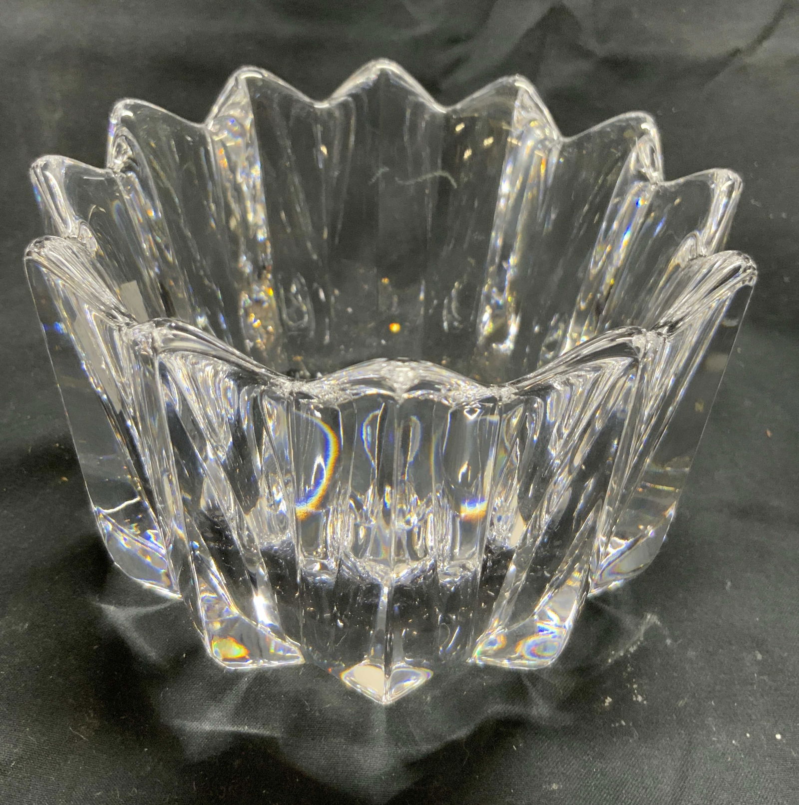 ORREFORS Fleur Ribbed Crystal Bowl: Underside is signed ORREFORS. Bowl is crystal appears to be in the FLEUR Pattern. Exterior is ribbed. Vessel has pointed tooth rim. Piece measures approximately 4.75 inches wide 3.75 inches tall. Bowl