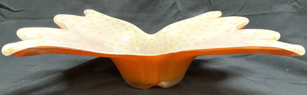 MURANO Art Gls Bowl W Gold Fleck Detail 10+in: Bowl appears to be MURANO Glass. Piece has orange exterior & white to interior with gold fleck polka dot detail. Bowl has floral form. Appears to be hand blown. Vessel measures approximately 13.5 inch