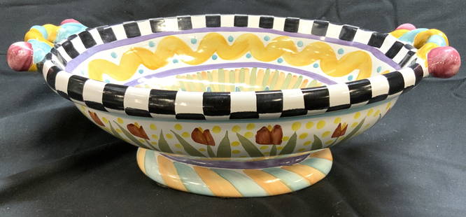 MACKENZIE CHILDS TAYLOR Ceramic Footed Bowl: Underside is inscribed MACKENZIE CHILDS. Piece also has trademarked tag. Bowl is footed. Piece has oval form. Bowl has intricate multi toned geometric, patterns, & floral detail. Bowl measures