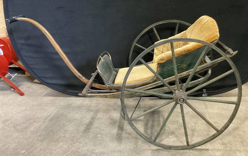 Antique Wooden Baby Stroller / Pram W Uph Seat: Antique Wooden Baby / Doll Stroller With Velvet Upholstery Seat. Painted a green hue. XL wheels to the sides. Handle to the front. Tufted nailhead design to the upholstery. Measures approx. 40D x 26W