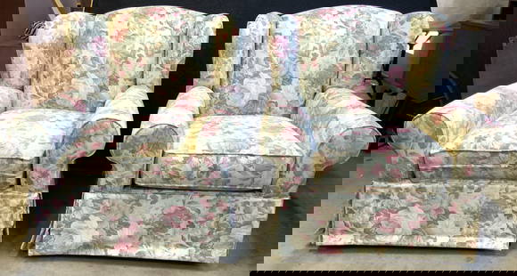 Pair Vintage Floral Winged Armchairs: Lot includes 2 armchairs. Each have winged backrests. Armchairs each have intricate multi toned floral and leaf detail. Chairs are each skirted. Each measures approximately 39 inches tall 37 inches wi