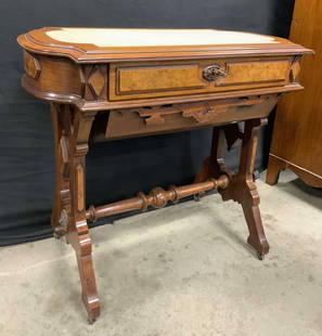 Victorian Walnut Sewing Table W Drawers & Casters: Sewing table is vintage and wooden. Piece has 4 gilt metal casters. Sewing table has 2 drawers with hand dovetailing. Top of piece has cream toned leather lining. Measures approx 34 inches wide 30 inc