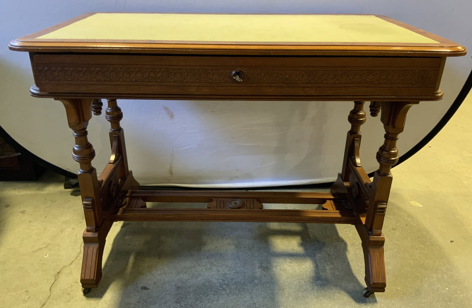 Antique Wooden Writers Desk Drawer & Casters: Writing desk appears to be antique possibly vintage. Piece is wooden. Desk has gilt metal casters. Desktop appears to be lined with tan toned felt. Measures approximately 42 inches long 31 inches tall