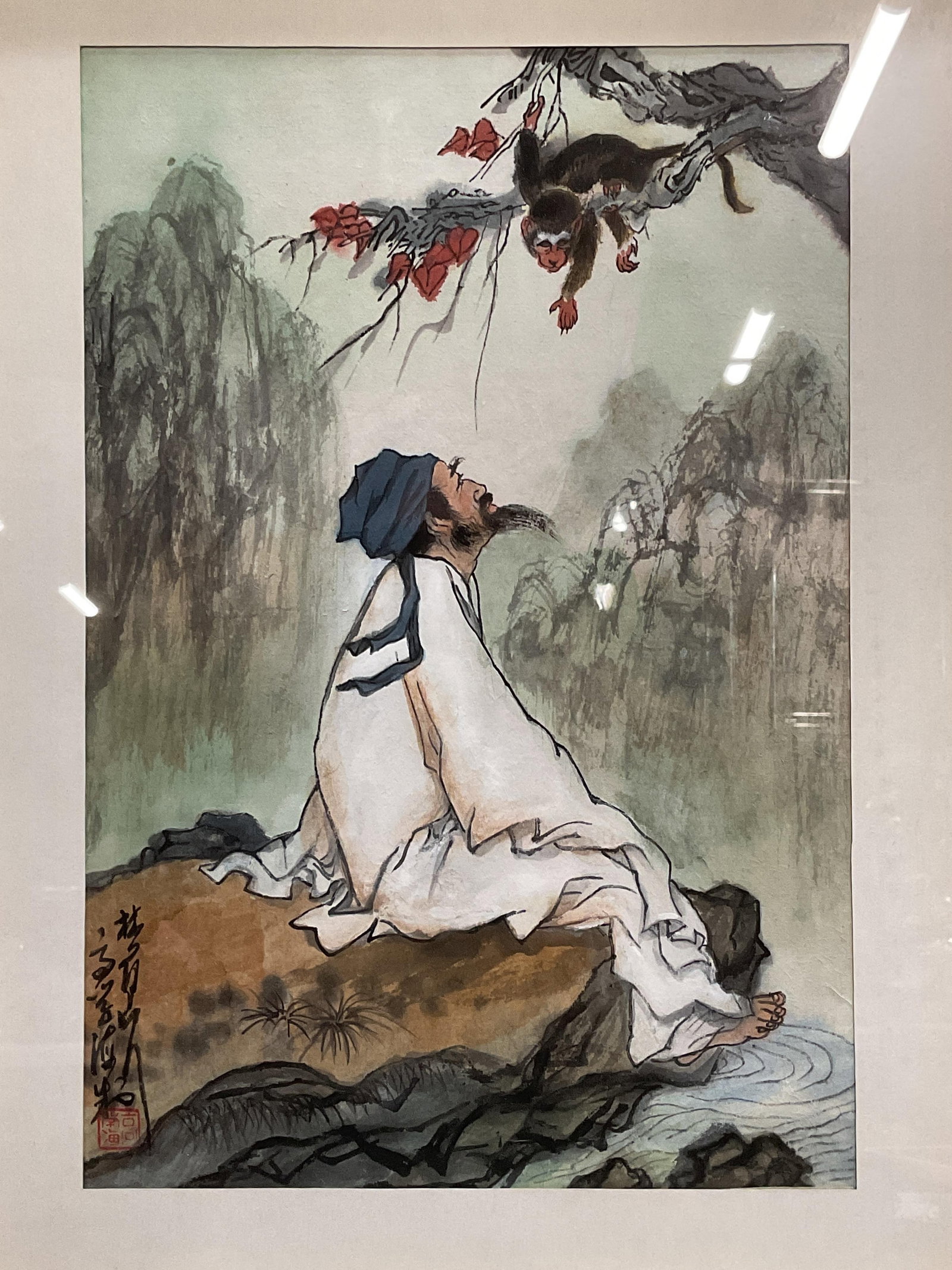 Framed Signed Chinese Guo Hua Ink Painting: Framed and matted Chinese ink and color pigment painting. Signed at lower left, seal stamp. Guo Hua traditional scene with man seated on rock and monkey in tree. Gilt wood frame, not examined out of f