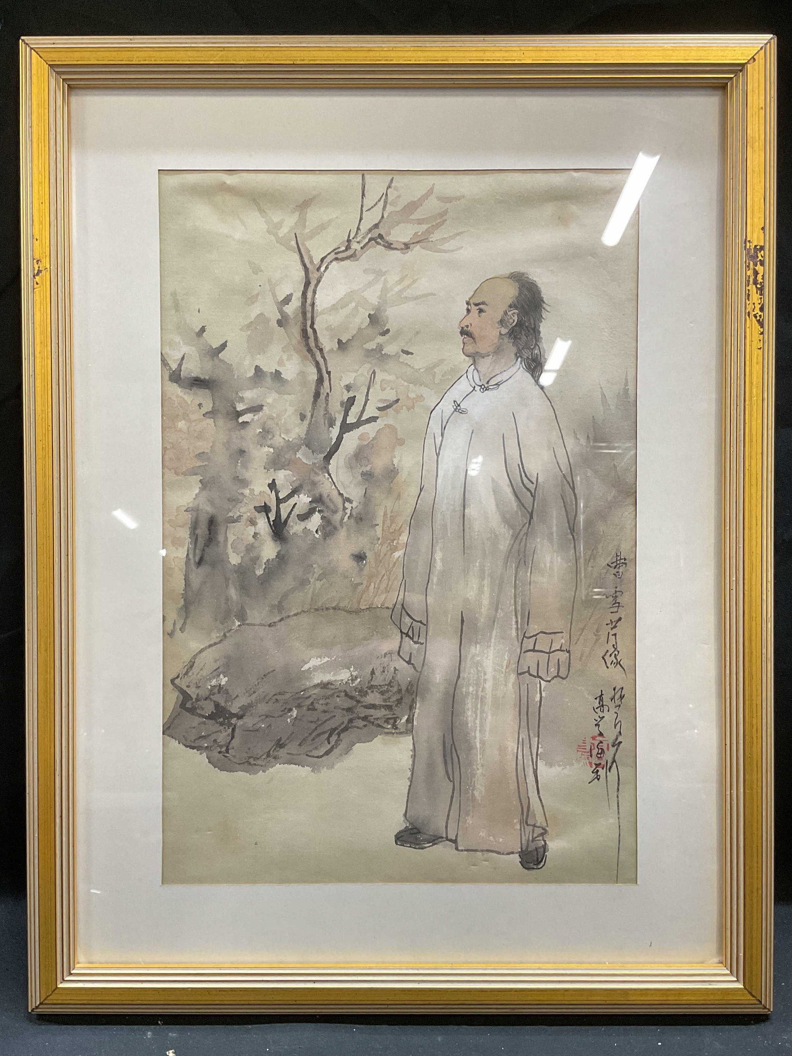 Framed Signed Traditional Chinese Ink Painting: Framed and matted Chinese ink painting. Signed at lower right, red seal stamp. Traditional Chinese scene with standing man and landscape background. Gilt wood frame, not examined out of frame. Frame m