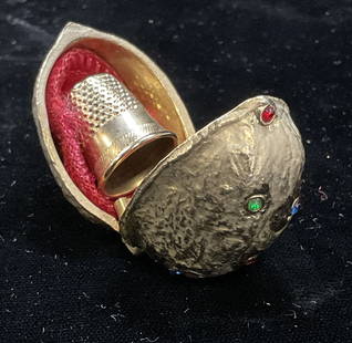 Vtg Gold Tn Walnut Shell Sewing Thimble Case: Vintage gold tone and multicolor crystal walnuts shell motif sewing and thimble case. Includes thimble and sewing accessories. Measures approx 1.5 x 1 x 1.25 inches. Piece has weight. Some wear includ