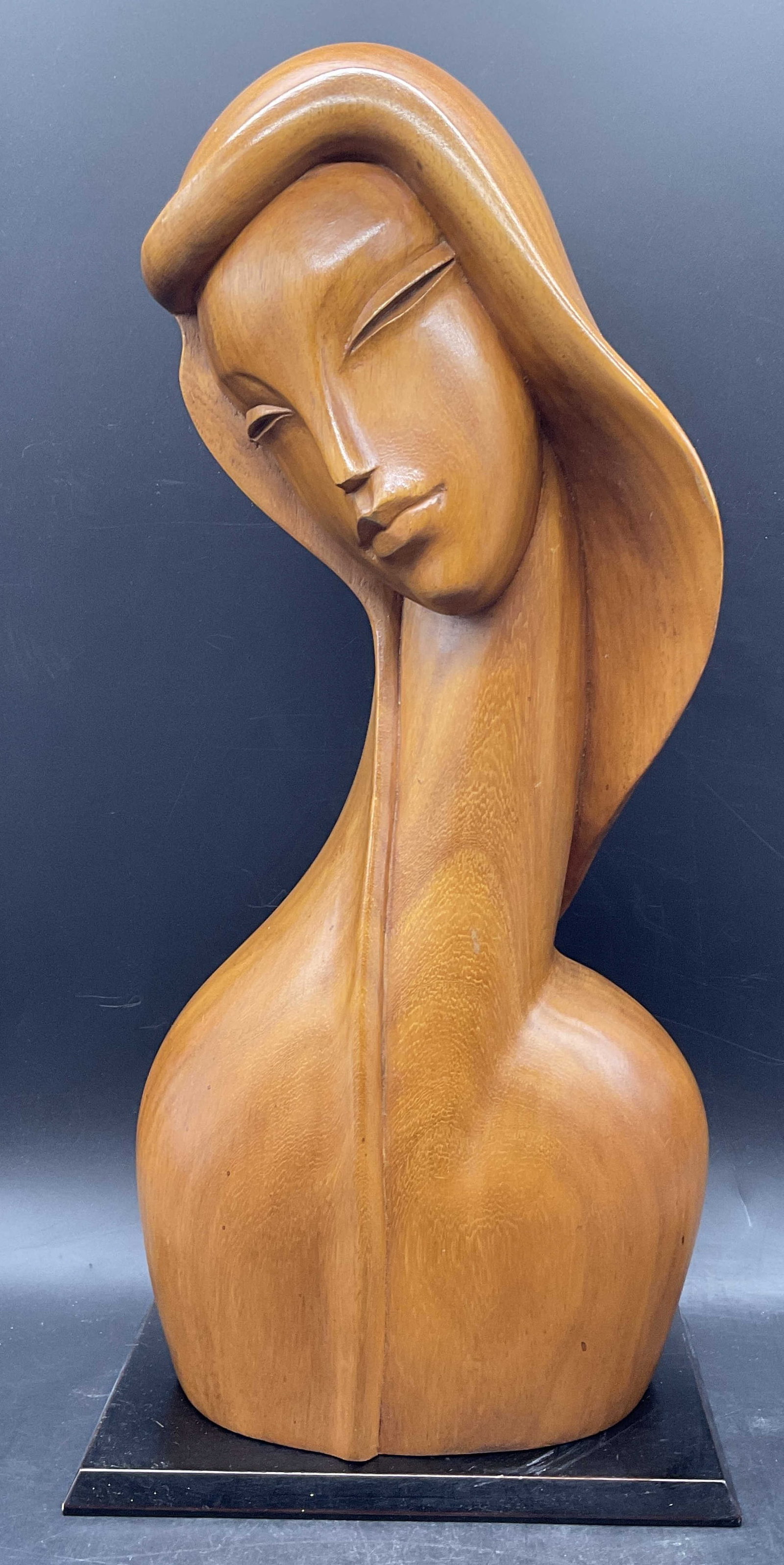Vintage Mid Century Modern Carved Wood Female Bust: Vintage Mid Century Modern carved wooden female bust sculpture. Sticker to the underside is worn, illegible. Comes with a black wooden stand. Not attached. Bust measures approx. 17.5H x 7.5W in. Measu