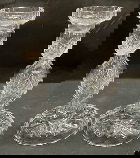 Pair Waterford Cut Crystal Candle Holders: Pair of Waterford cut crystal candle holders. Wide bases with tapered detail on body. Geometric diamond pattern. Signed on bases. Measure approx 4 x 7.5 inches each. Some wear including scratching obs