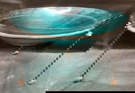 Arts Pira Tripod Stand Glass Centerpiece Bowl: Arts Pira cast metal tripod stand centerpiece. Ribbed blue glass bowl. Signed on label to stand. Total dimensions approx 16 x 9 inches. Some wear including scratching observed. Arts lira, arts lira ce