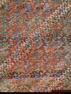 Vintage Handmade Fringed Persian  Wool Area Rug: Rug is handmade. Piece is vintage, appears to be Persian. Rug is red with intricate multi toned floral & geometric detail. Rug has short cream toned fringes at edges. Piece measures approximately 101