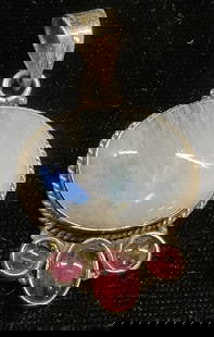 Sterling Silver Moonstone & Garnet Pendant: Vintage sterling silver pendant with moonstone and red semiprecious stones. Appear to be garnet. Marked sterling. Measures approx 1.25 x 1 inches. Total weight 9.4 grams. Some wear including scratchin