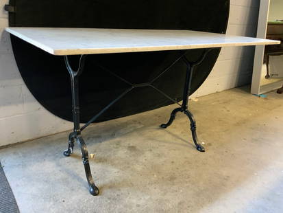 Vintage Marble Top Iron Base Dining Table: Dining Table is vintage. Piece has white toned marble top and black toned iron base. Base has 4 feet. Supports has x form stretcher in between. Table top has rectangular form with rounded corners. Tab