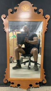 Chippendale Style Mirror W Inlaid Plaque 43in: Mirror is light brown toned and wooden. Piece has carved frame with inlaid oval medallion detail depicting vase. Chippendale style wall mirror. Mirror measures approximately 43 inches tall 22 inches w