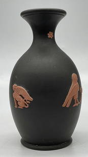 WEDGWOOD ENGLAND Black Basalt Jasperware Vase: WEDGWOOD ENGLAND Black Basalt Jasperware Vase. Raised Egyptian motifs to the sides. Underside reads WEDGWOOD. Verbiage underside is worn. Measures approx. 4.5H x 2.25W in. Surface wear, residue, and d