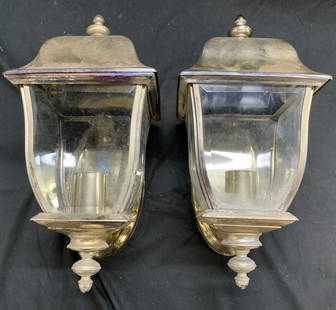 Pair Brass & Glass Wall Lantern Light Fixtures: Lot includes 2 lantern wall light fixtures. Each piece is gold toned and brass with beveled glass windows, backsides of each have oval forms. Tops of each piece have finial form structures. Each measu