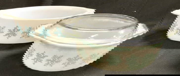PYREX Lot 2 Snowflake Serving Dishes: Undersides of each read PYREX. Lot includes 2 serving dishes. One dish includes clear lid. Each dish is white toned with snowflake detail. Sides of each dish have handles. Largest dish measures approx