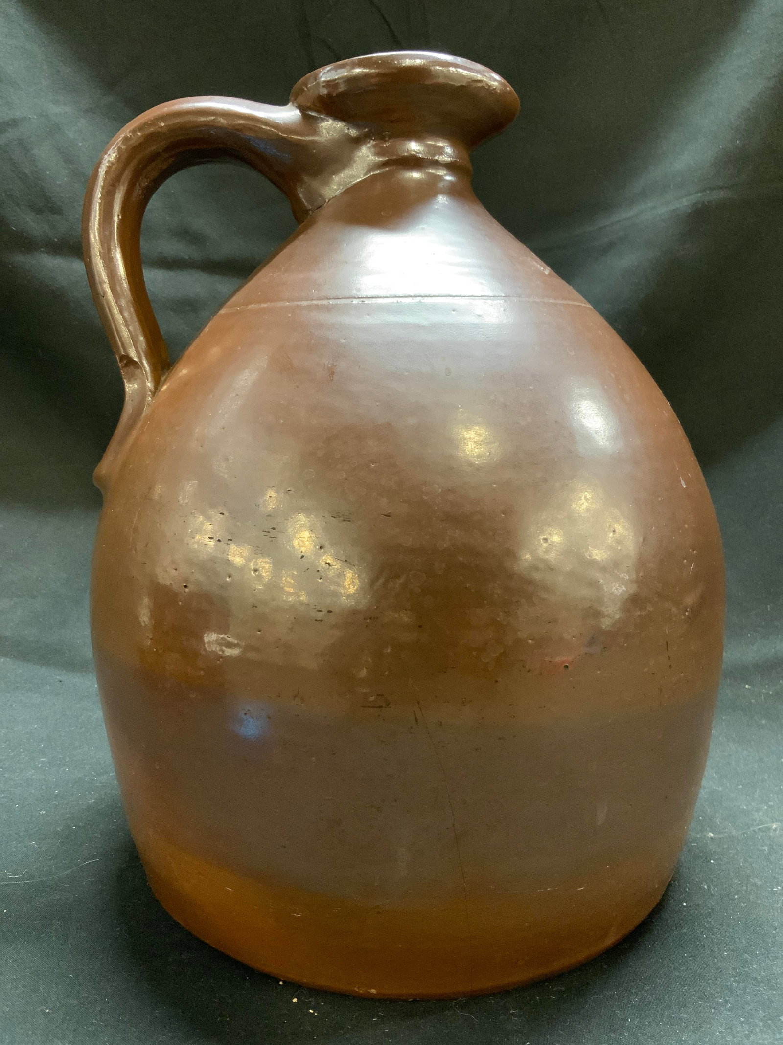 LYONS Handmade Ceramic Crock Brown 10.5in: Crock is inscribed LYONS. Crock is brown toned and ceramic. Piece appears to be hand crafted. Crock has handle and spout. Appears to be vintage. Piece measures approximately 10.5 inches tall 8 inches 