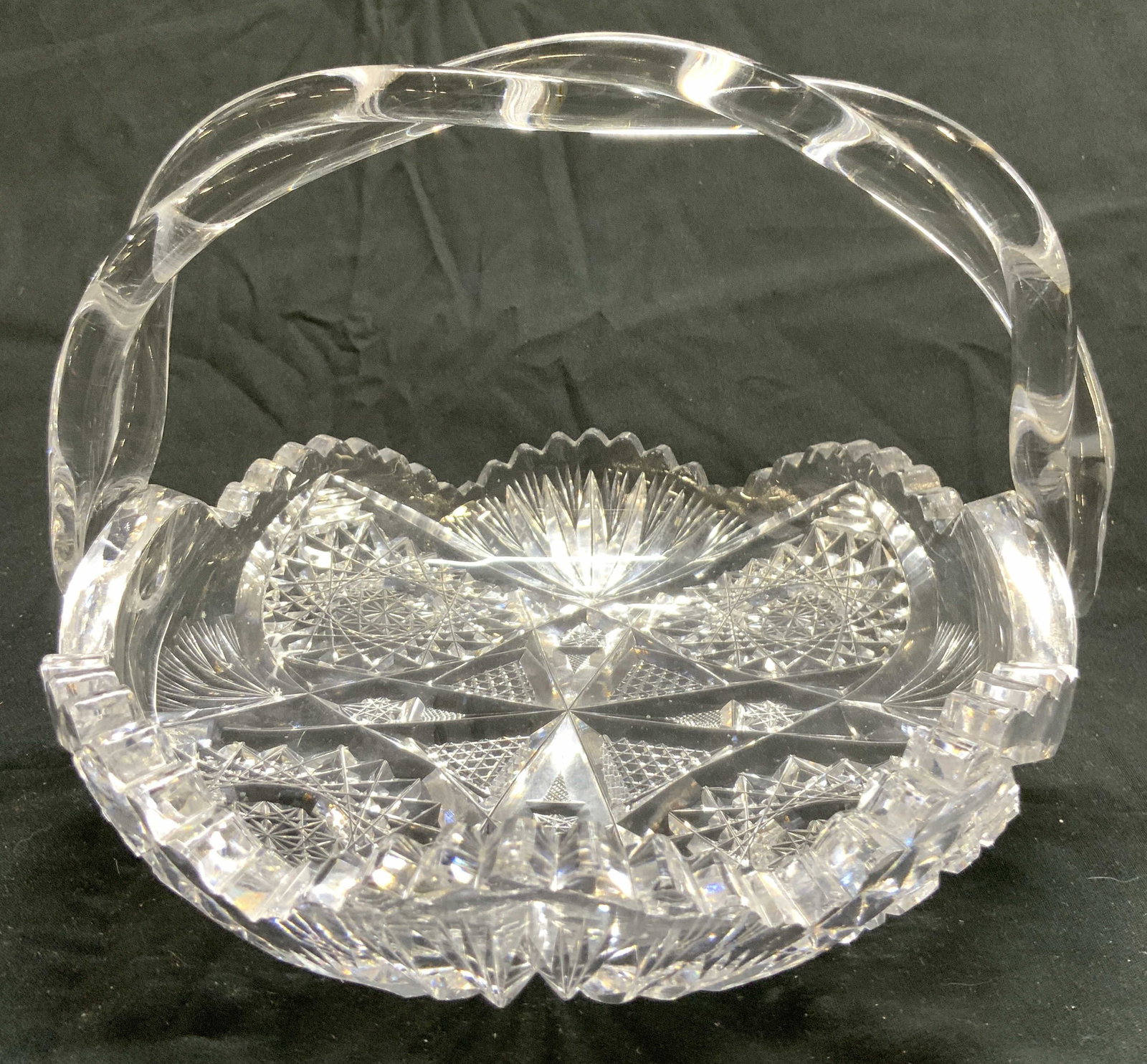 David Walsh ABP Brilliant Cut Crstl Bskt Twst Hndl: David Walsh Union Glass ABP Brilliant Cut crystal Basket Twist Handle. Basket is cut crystal. Piece has intricate geometric relief detail. Basket has twisted arch form handle. Piece has toothed rim. M