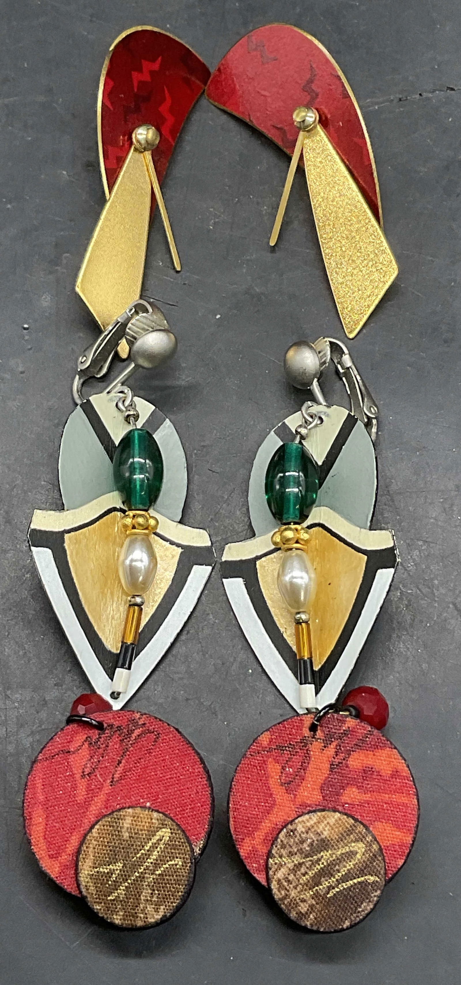 Lot 3 Vintage Handmade Clip On Earrings: Lot 3 Vintage Handmade Clip On Earrings. Crafted from metal, plastic, paper, and fabric materials. Earrings with the beaded detail measure approx. 2L x 1W in. Discoloration, residue, and surface wear