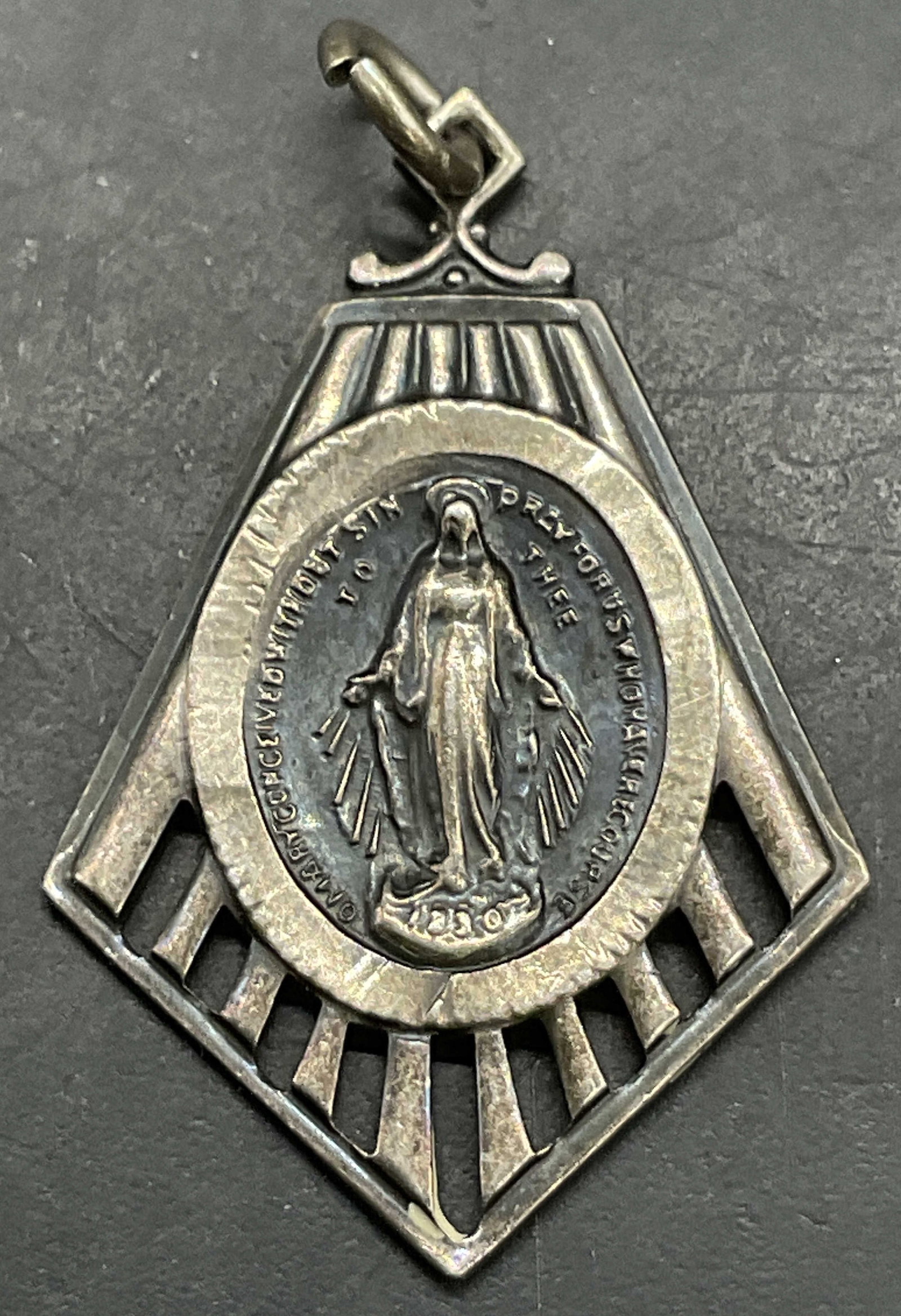 STERLING SILVER Mother Mary Religious Pendant: STERLING SILVER Mother Mary Religious Pendant. Reverse reads STERLING. Obverse features a prayer / partial prayer. Measures approx. 1L x .75W in. Total weight .08 ozt. Surface wear consistent with age