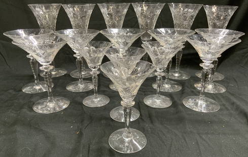 Set 17 Tiffin-Franciscan Blue Bell Crystal Barware: Lot includes 6 champagne flutes, 7 martini glasses, & 4 cordial glasses. Each piece appears to be Tiffin Franciscan Blue Bell. Pieces each have etched floral and leaf detail. Champagne flutes measure
