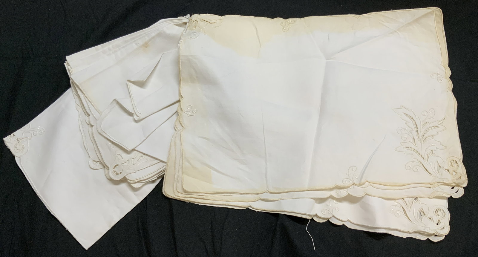 Lot 15 Vintage Cloth Placemats & Napkins: Lot includes 8 placements and 7 napkins. Each piece is cream toned cloth. Placemats have scroll, leaf & pierced detail. Placemats each measure approximately 17.5 inches long 12 inches wide. Placemats,