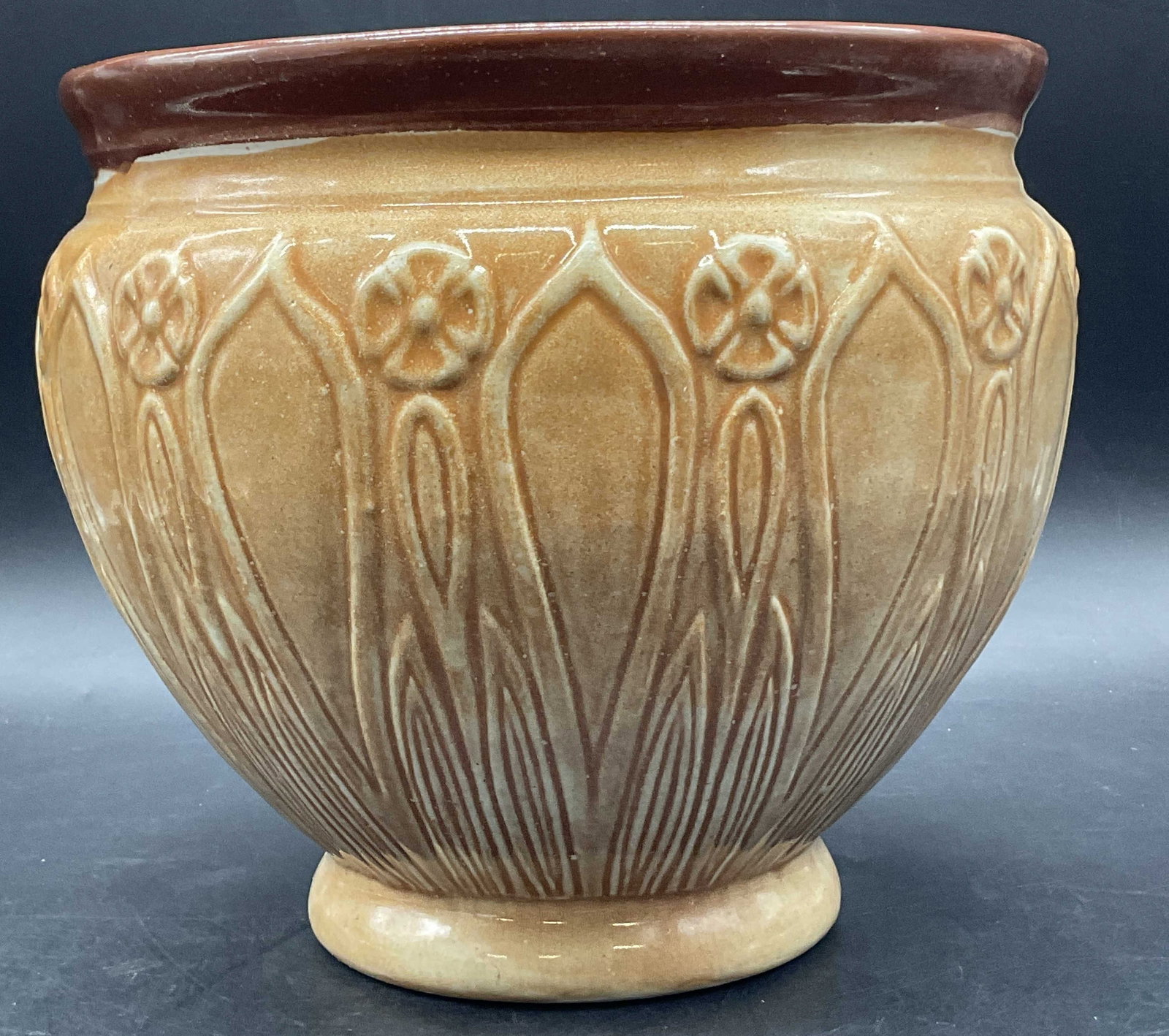 FIORIWARE Floral Motif Pottery Planter: FIORIWARE Floral Motif Pottery Planter. Raised florals and geometric designs to the piece. Underside signed FIORIWARE. Thick walled. Measures approx. 7.5H x 8W in. Detritus to interior. Surface wear, 