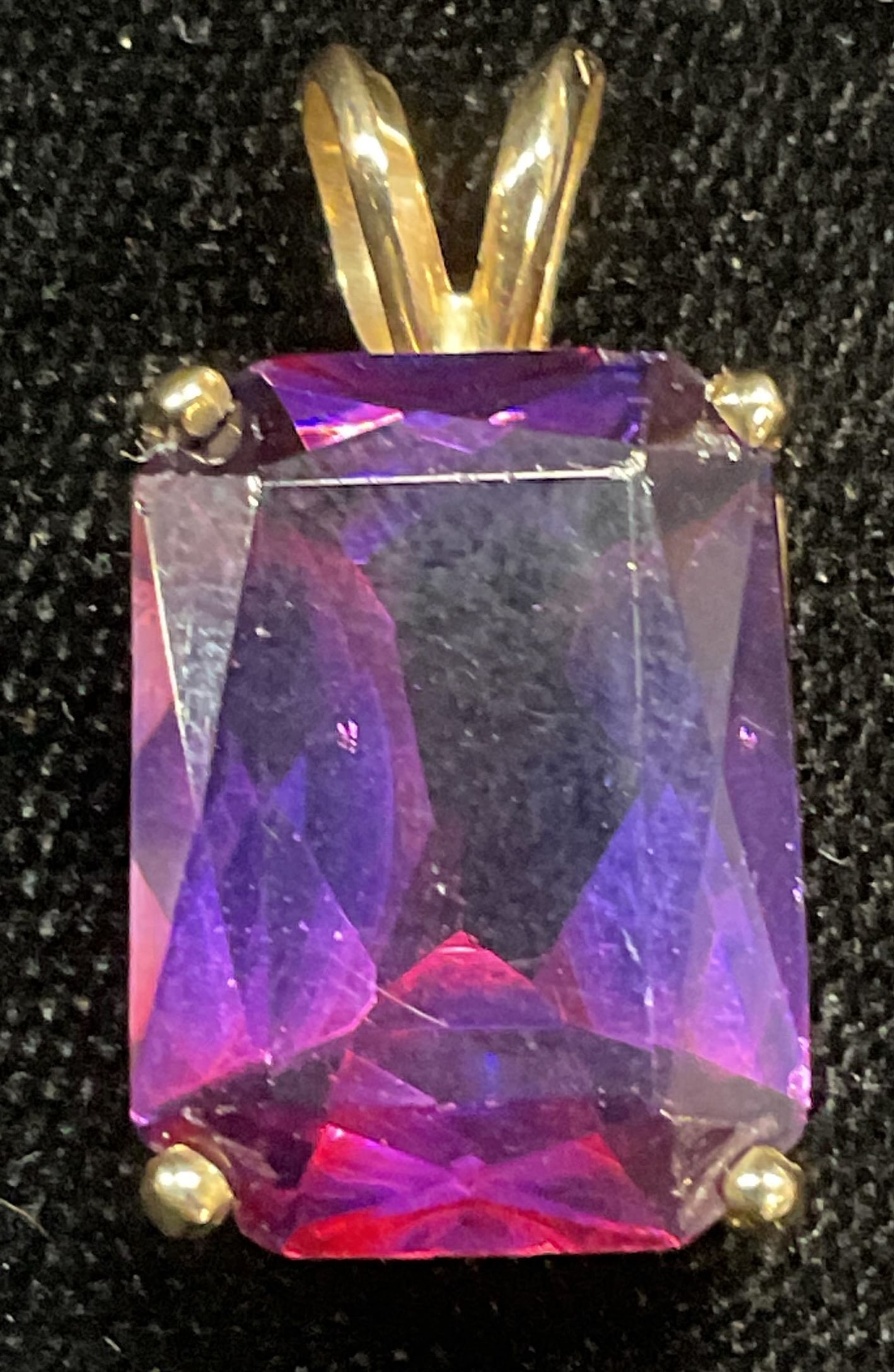 Gold Tone Purple Glass Stone Pendant: Gold tone pendant with purple emerald cut glass cabochon. Measures approx 5/8 x .5 inches. Some wear including scratching observed. Jewelry, estate jewelry, costume jewelry, cocktail jewelry, fashion
