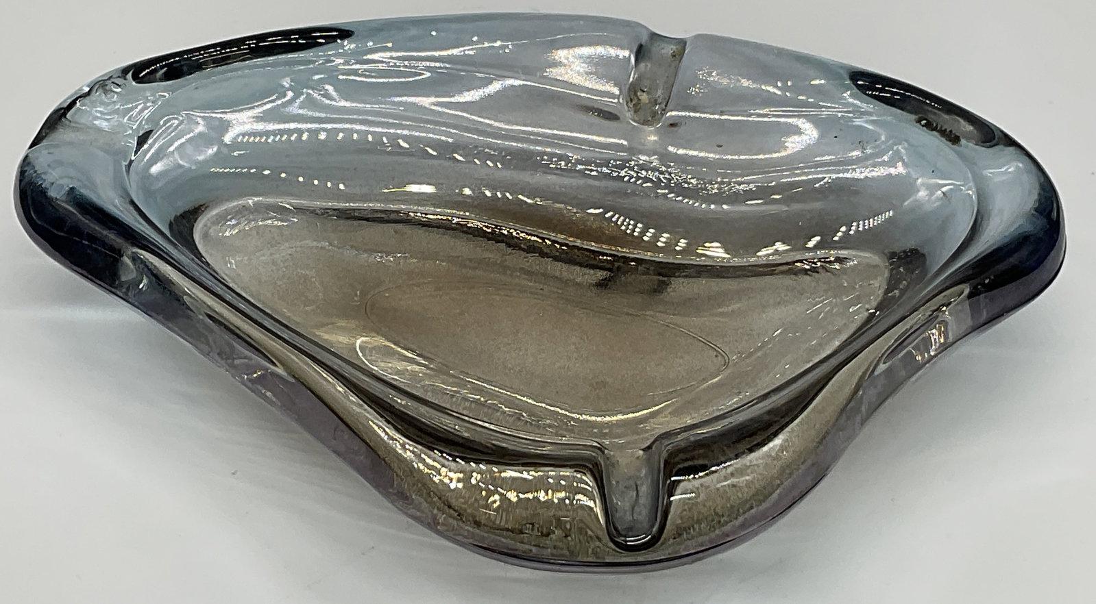 Freeform Amoeba Smokey Art Glass Trinket Dish: Freeform Amoeba Smokey Art Glass Trinket Dish / Ashtray. Iridescent smokey hue to the piece. Divots to the edge. Measures approx. 1.5H x 7W in. Chipping and surface wear present. home decor, home acce