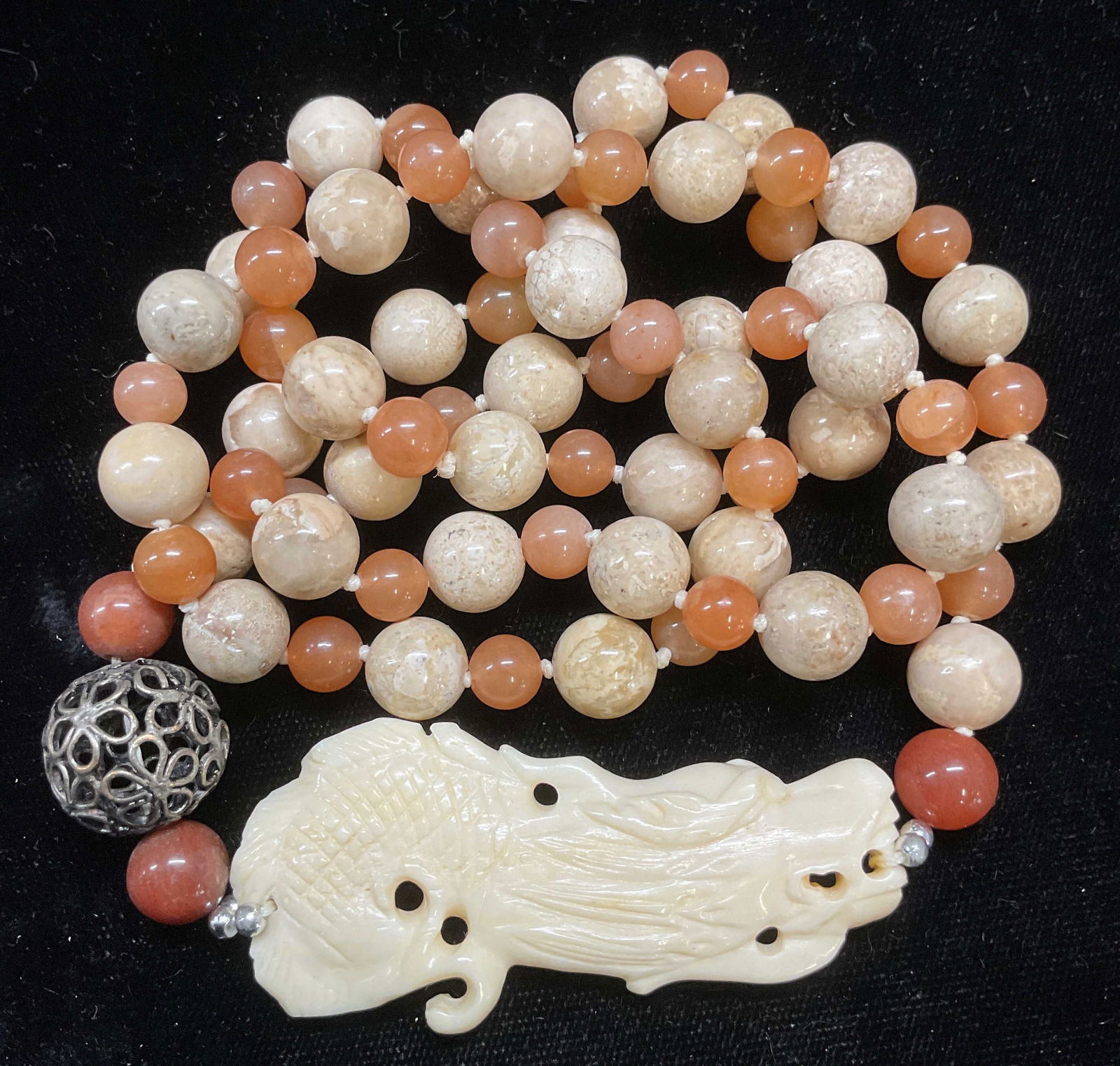 Semiprecious Beaded Dragon Pendant Necklace: Semiprecious orange and tan beaded stone necklace with faux bone dragon pendant. Drop length approx 14 inches. Some wear including scratching observed. Jewelry, estate jewelry, costume jewelry, cockta