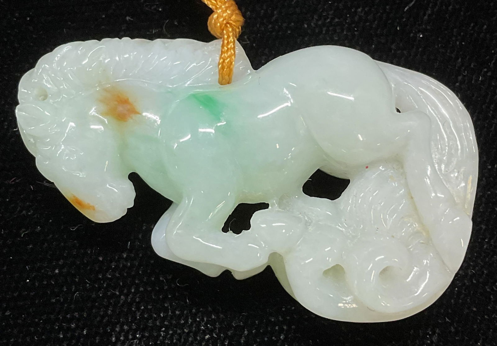 Carved Jade Horse Pendant Necklace: Carved jade horse pendant on tan cord. Drop length approx 13 inches. Pendant approx 1 x 1.5 inches. Some wear including scratching observed. Jewelry, estate jewelry, fine jewelry, cocktail jewelry, fa