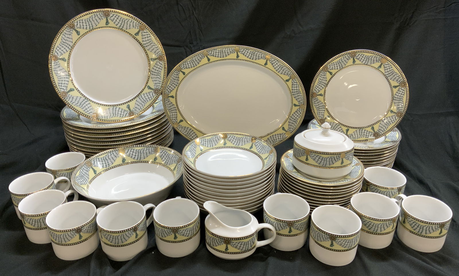 64 MUIRFIELD Porc Green & Gold Drapery Tableware: 64 MUIRFIELD Porc Green & Gold Drapery Tableware 1 serving platter, 1 bowl, 12 cups, 1 creamer, 1 sugar bowl w lid, 12 dinner plates, 12 small bowls, 12 saucer plates & 12 salad plates. Pieces have a