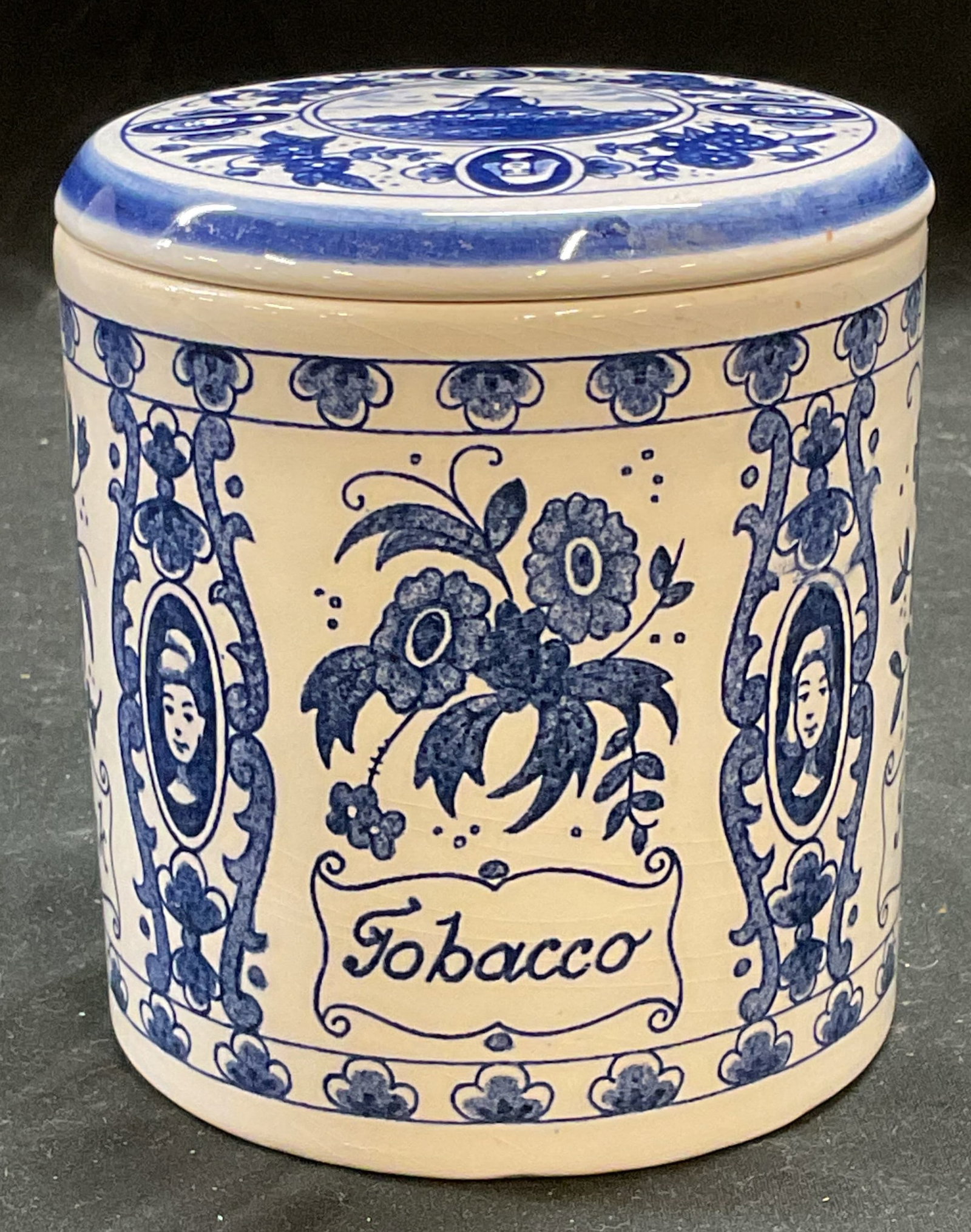 Vtg Delft Blauw Porcelain Tobacco Jar Holland: Vintage Delft Blauw hand painted porcelain tobacco jar with lid. Blue and white. Floral and figural motif. Signed. Measures approx 4 x 4.5 inches. Some scratching observed. Tobacco jar, porcelain toba