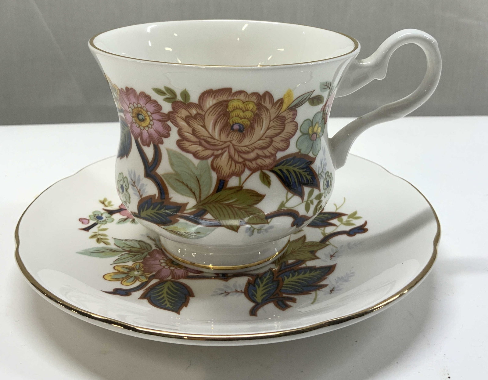 Royal Grafton Bone China Teacup & Saucer ENGLAND: Royal Grafton Bone China Teacup & Saucer ENGLAND Pieces have a floral design & gold accents. Signed & marked on underside. Reads Royal GRAFTON. Fine bone china & MADE IN ENGLAND. Surface wear consiste