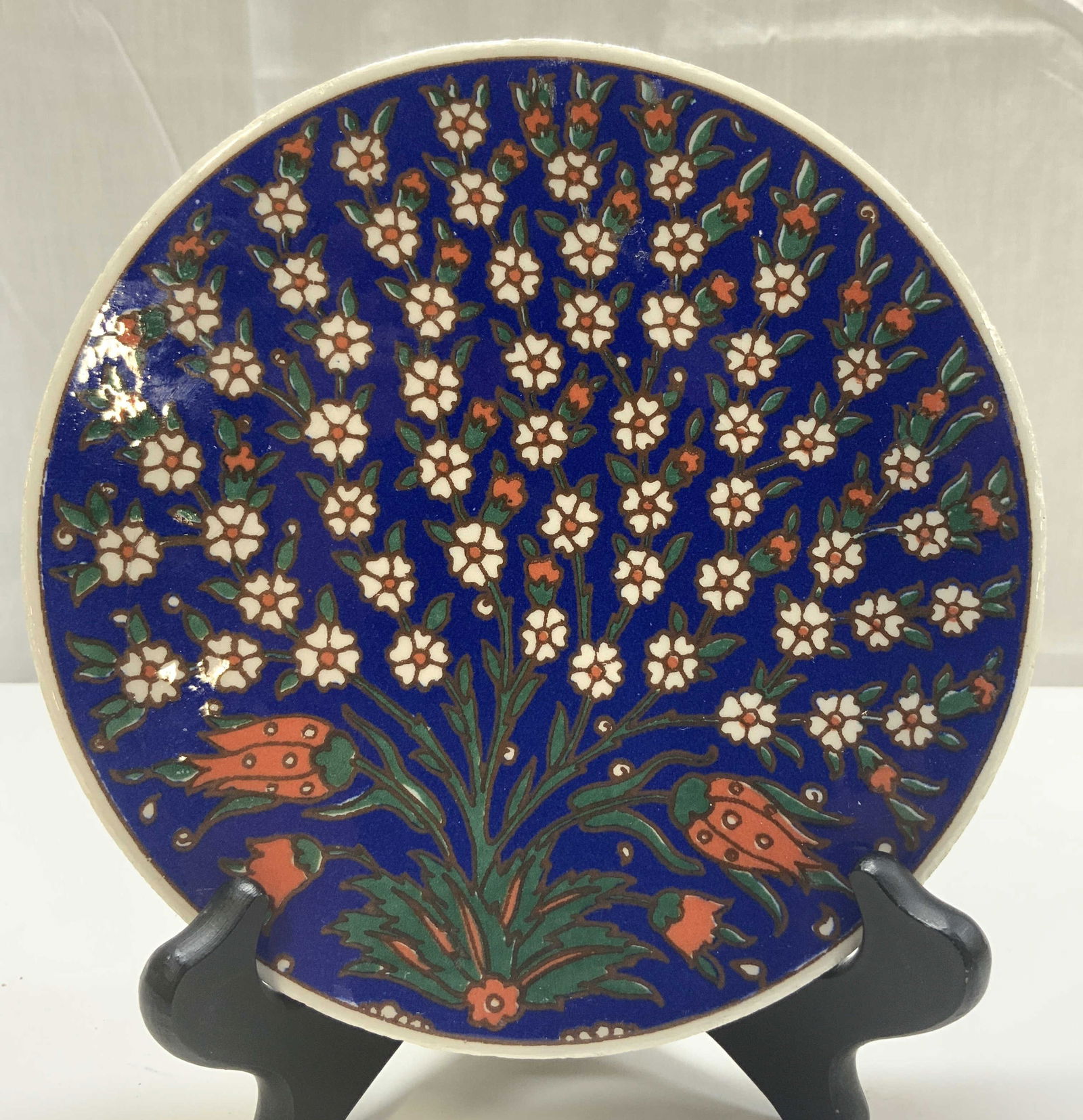 Floral & Tulip Blue Wall Ceramic Plate: Floral & Tulip Blue Wall Ceramic Plate Hand-painted ceramic plate featuring a vibrant blue background adorned with a floral design. Surface wear consistent to age, use & exposure. Measurements: length