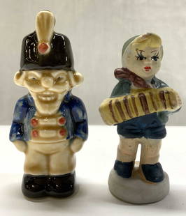 2 Miniature Porcelain Figurines GOEBEL GERMANY+: Lot has a vintage GOEBEL porcelain figurine of a toy solider nutcracker & a young figurine playing an accordion. Toy soldier has sticker on underside. Reads GOEBEL GERMANY. Surface wear consistent to