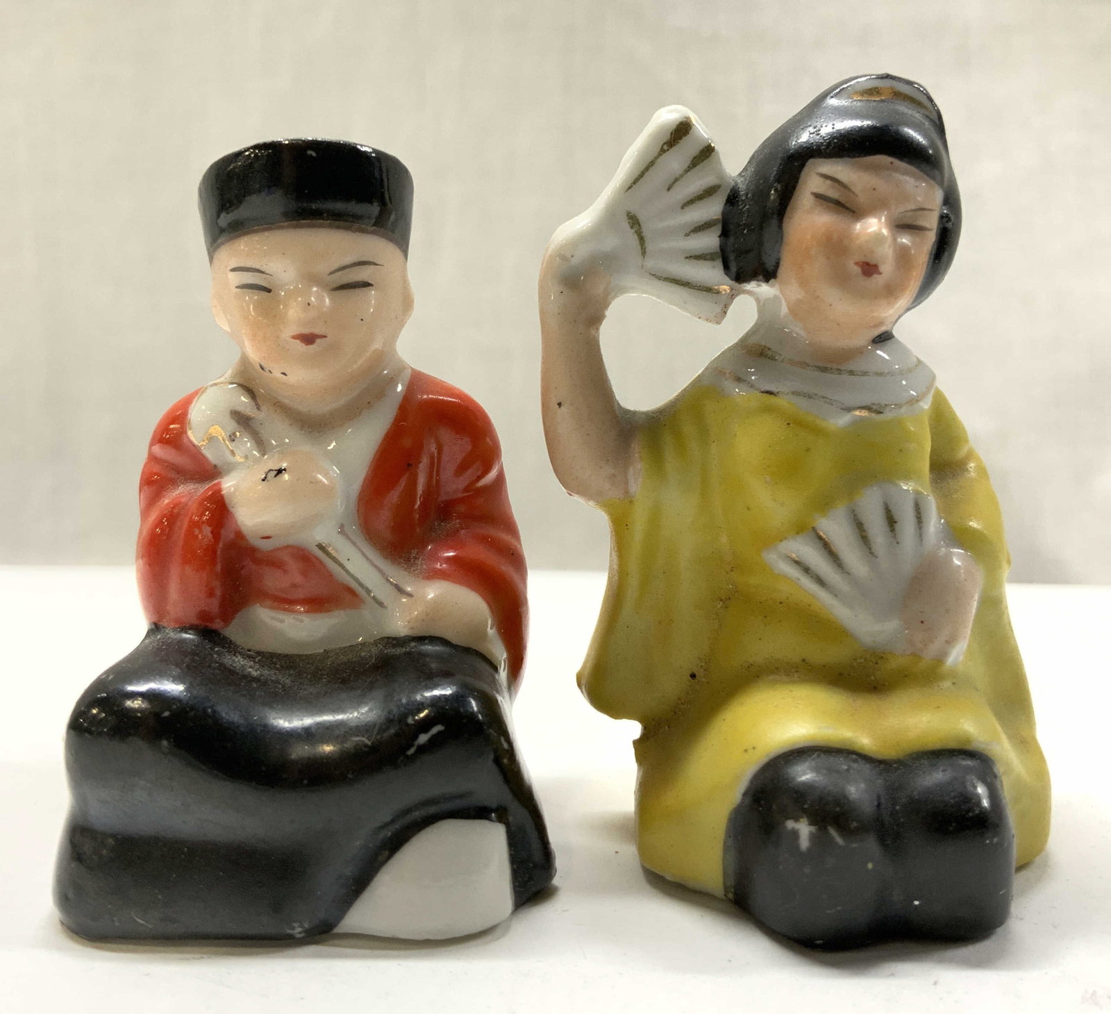 Vntg Asian Man & Women S&P Shakers JAPAN: Vntg Asian Man & Women S&P Shakers JAPAN Salt & pepper shakers depicting an Asian man & women wearing traditional attire. Surface wear consistent to age, use & exposure. Measurements: length 1.4in x w