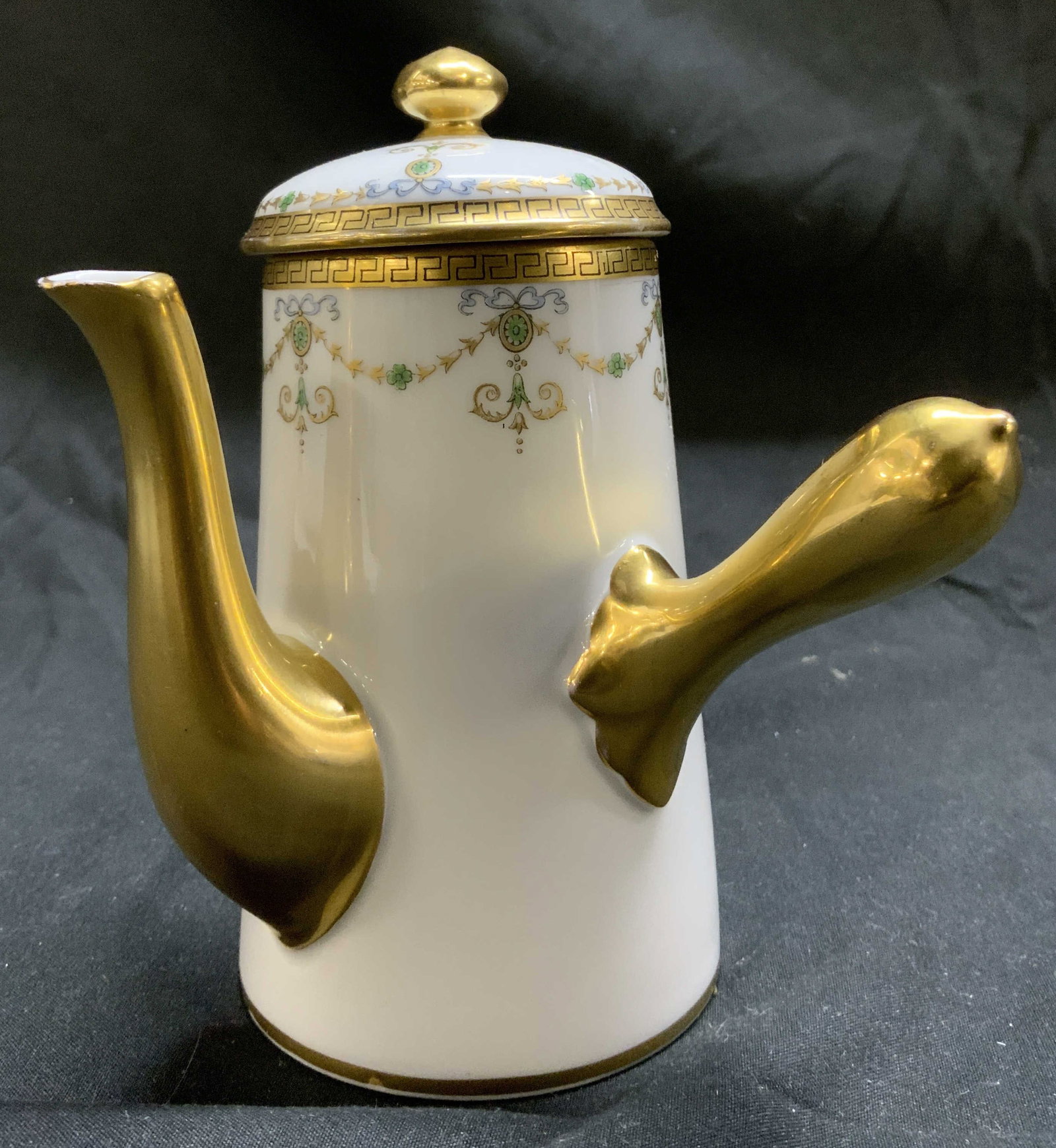 LIMOGES Porcelain Gold Chocolate Pot FRANCE: LIMOGES Porcelain Gold Chocolate Pot FRANCE Chocolate pot featuring a white base with intricate gold detailing. Pot has a Greek key pattern & floral elements. Signed & marked on underside. Surface wea