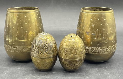 Lot 4 Brass Tone Metal Seasoning Shakers & Cups: Lot of Four Brass Tone Metal Seasoning Shakers & Cups. A pair of salt and pepper shakers with a pair of cups. The pieces all feature etched metalwork designs. The cups measure approx.3.75H x 2.5W in.