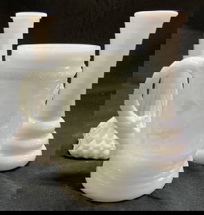 Vintage Milk Glass Bud vases & Mug: Lot includes 2 Bud vases & 1 mug. Each are white toned milk glass. Pieces each appear to be vintage. Mug has beveled figural detail. Largest vase measures approx 6 inches tall 2.75 inches wide. Mug, v