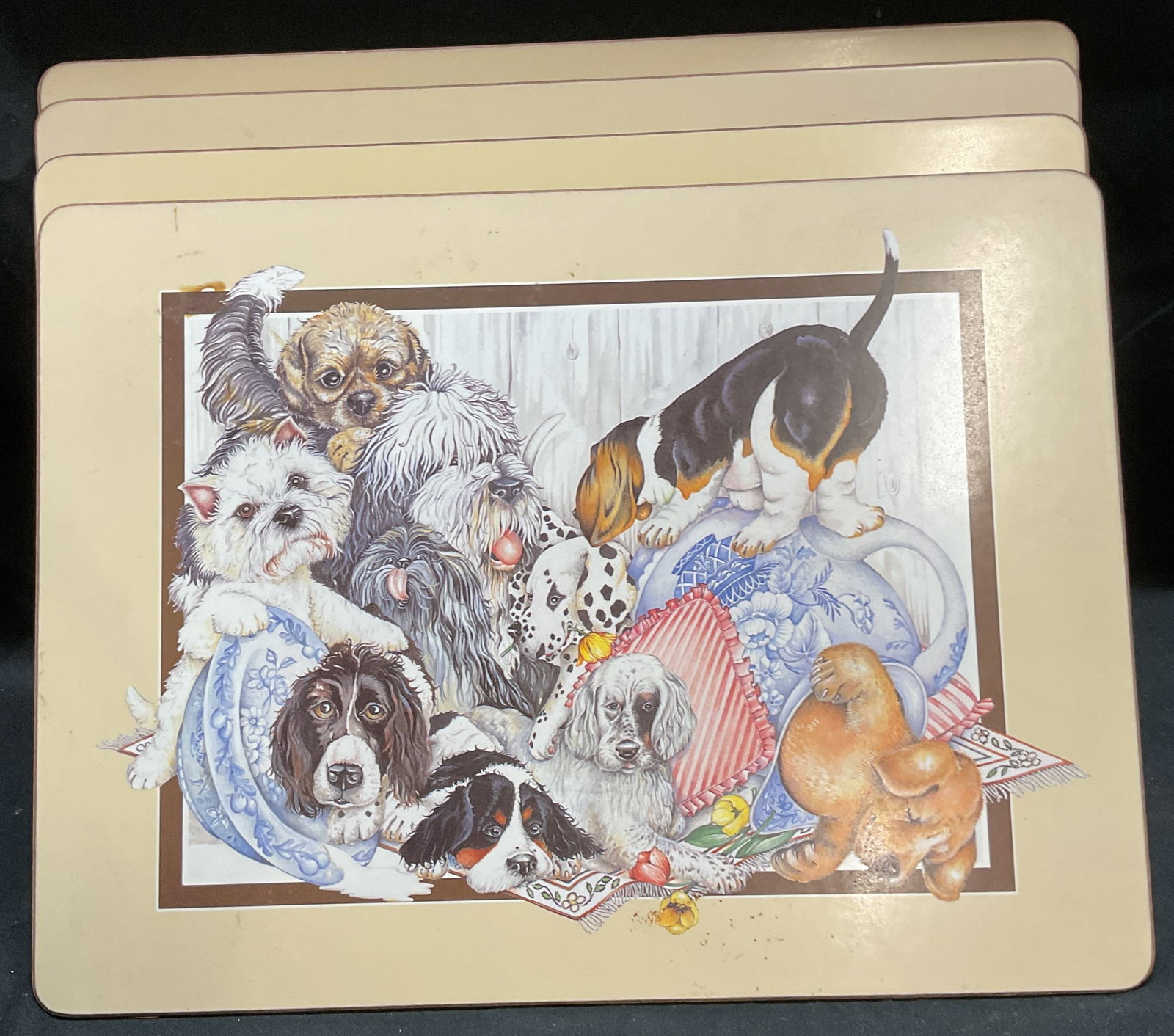 Set 4 Puppy Dog Motif Place Mats: Set of 4 puppy motif place mats. Cork lined underside. Prints on board. Measure approx 11.5 x 15.75 inches. All pieces have some wear including scratching. Placemat, puppy place mat, dog place mat, ta