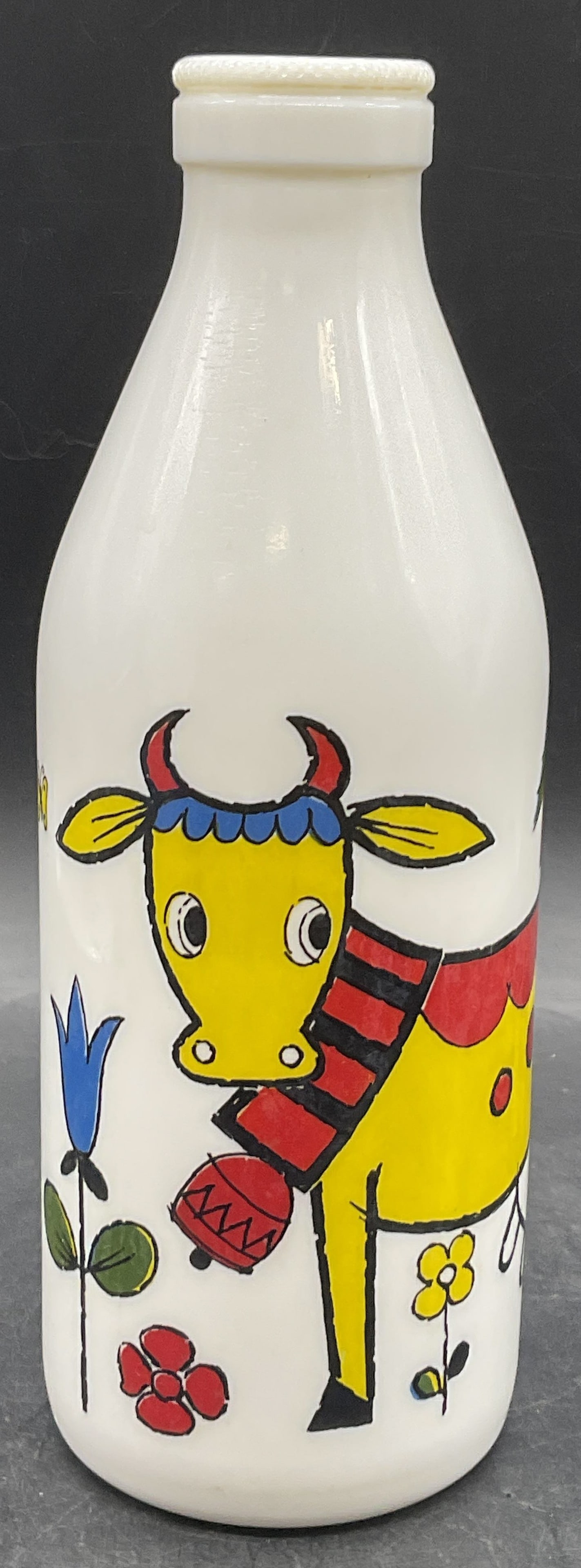 EGIZIA Vintage White Glass Cow Motif Milk Bottle: EGIZIA Vintage White Glass Cow Motif Milk Bottle. Colorful cow in a nature setting to the obverse. Underside trademarked. Measures approx. 10H x 3.5W in. Seam present. Discoloration, surface wear, and