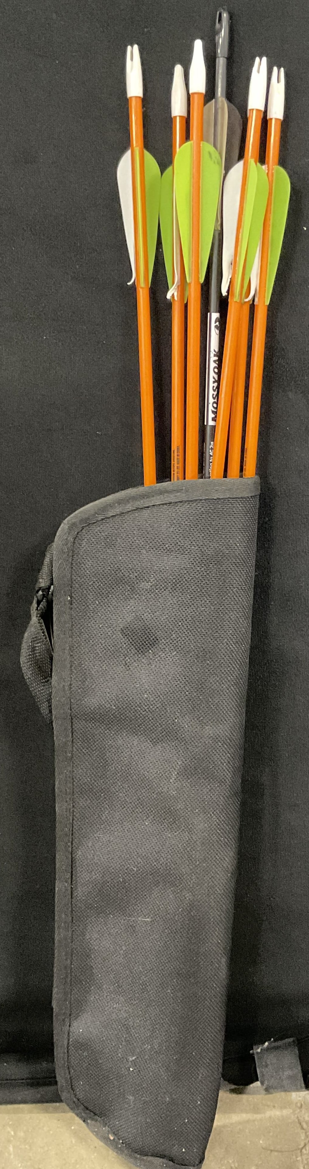 DEER RINGER YOUTH & MOSSY OAK Arrows W/ Case: Deer Ringer Youth arrows and a Mossy Oak arrow. The arrows are orange or black with silver toned metal tips. Pieces are contained in a black fabric case. Case measures approx. 18L x 5W in. Discolorati