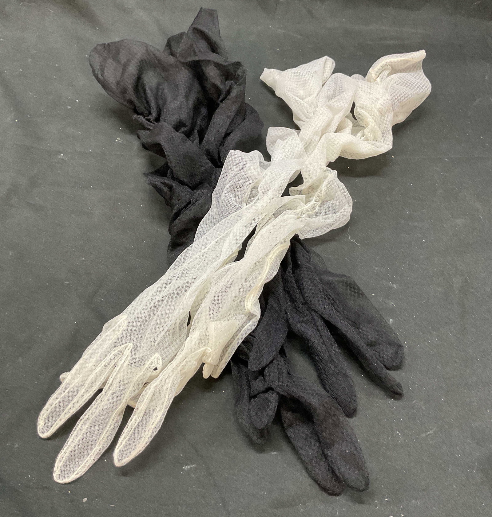 Set 2 Vtg Sheer Black White Opera Length Gloves: Set 2 vintage sheer black and white opera length gloves. Material appears to by nylon. Pieces are black and white. Scrunched up look. 18.5L x 3.5W inches. Discoloration present. Vintage gloves, gloves