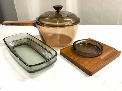 Lot 3Tableware PYREX Gls Pot W Lid & More: Lot includes 1 glass pot with lid trademarked PYREX 1 trinket dish which sits in wooden slot, & 1 glass serving dish. Pyrex Pot with handle and lid has sienna tone. Measures approximately 11 inches de