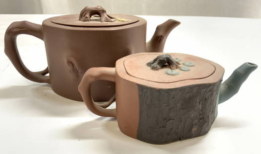 Lot 2 Asian Ceramic Teapot & Creamer Dshs w Lids: Undersides are inscribed with Asian characters. Lot includes 1 teapot with lid and 1 creamer dish with lid. Each piece is ceramic. Each have tree stump forms. Vessels each include lids. Teapot measure