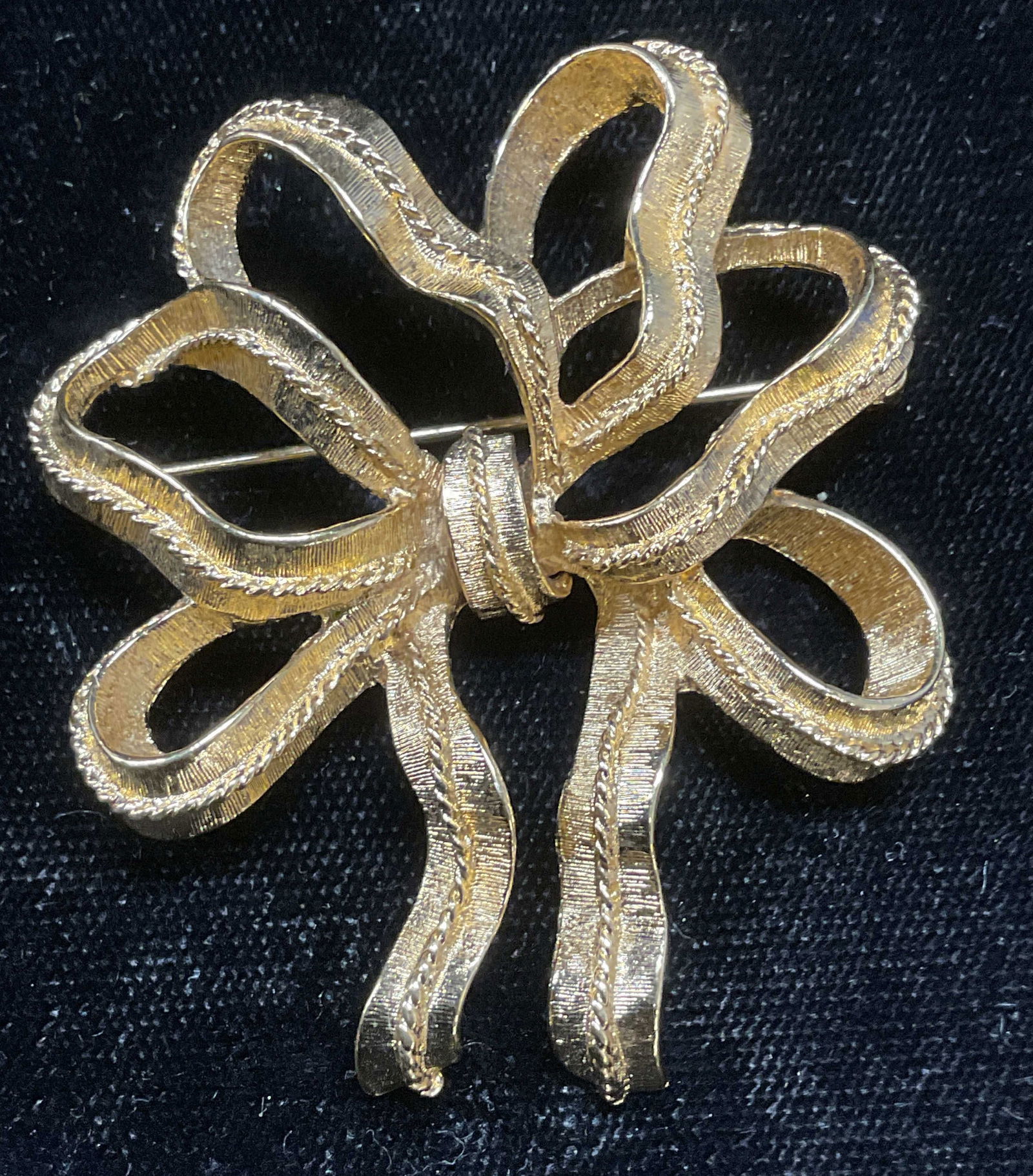 Vintage Monet Gold Tone Bow Brooch: Vintage signed Monet gold tone ribbon bow motif brooch. Measures approx 2 x 1.75 inches. Some wear including scratching observed. Jewelry, costume jewelry, estate jewelry, cocktail jewelry, fashion je