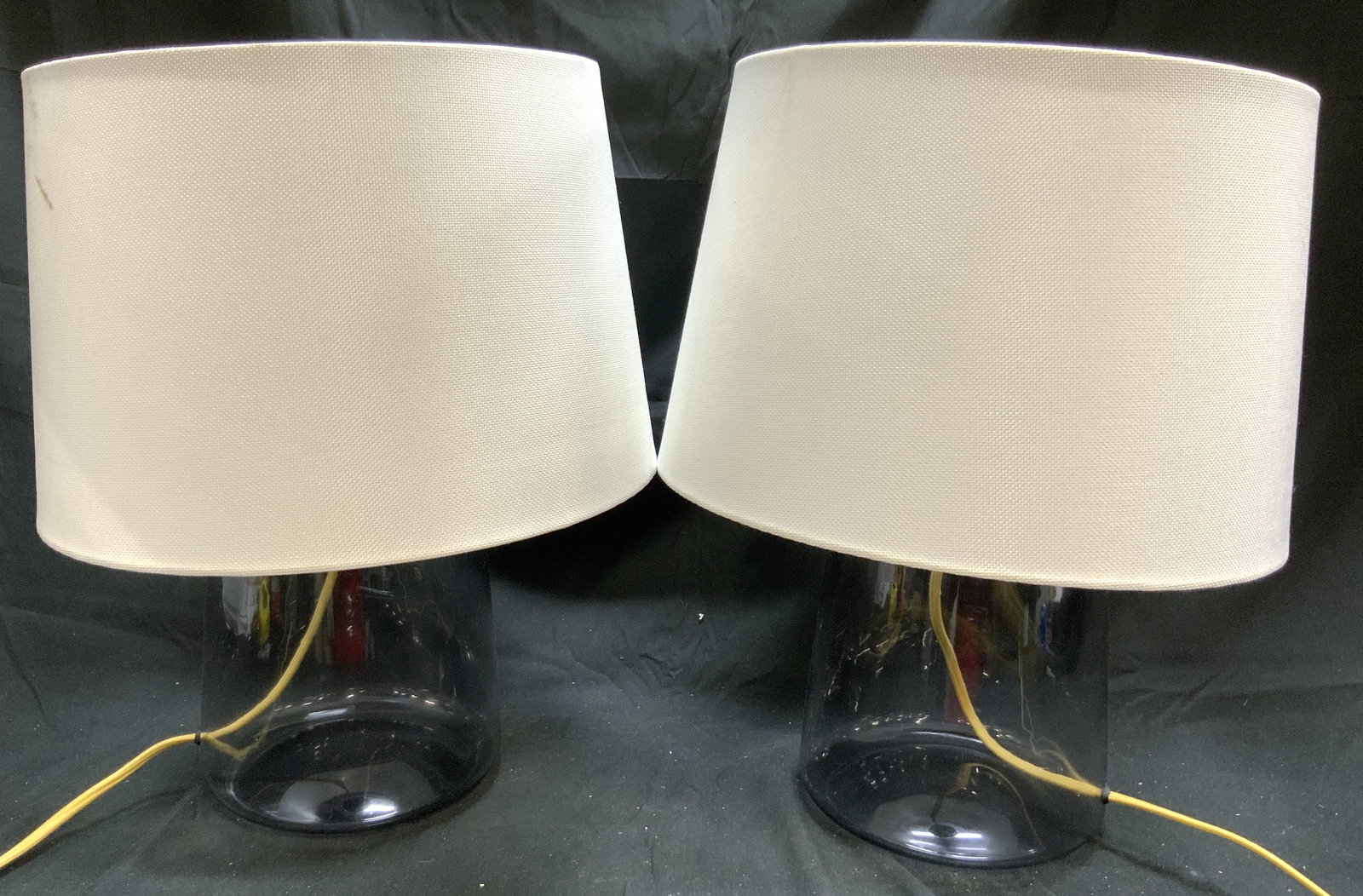 Pair Art glass Lamps W Harps & Shades: Lot includes 2 lamps. Each are glass. Lamps each include white toned shades & gilt metal harps. Each have twist switches to bulb sockets. Lamps each measure approximately 18 inches tall 7 inches wide
